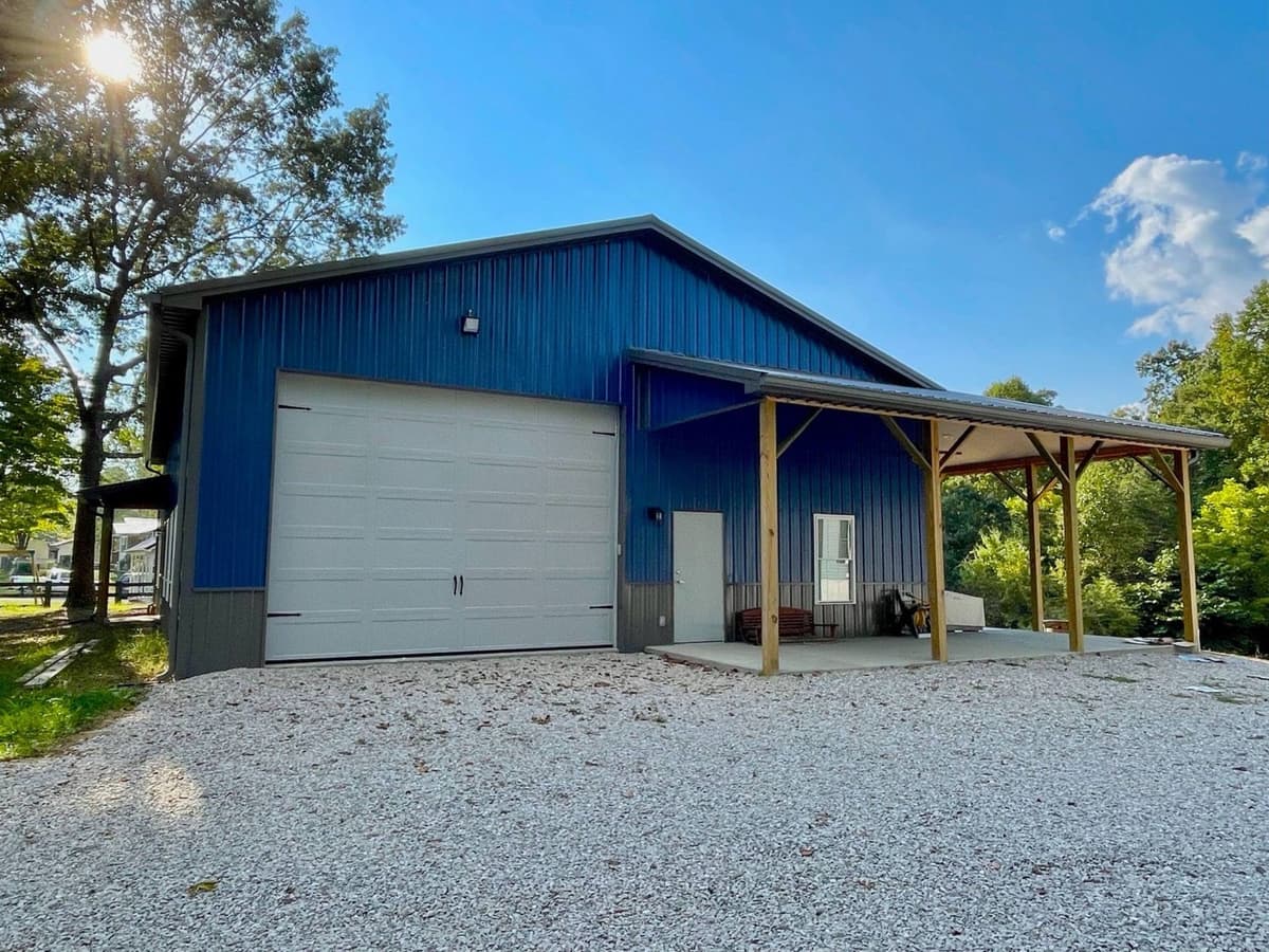 Blue barndominium with metal roofing and siding